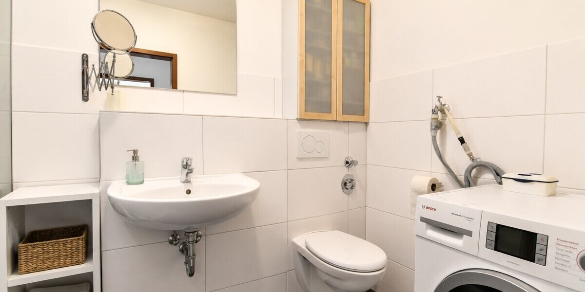 Badezimmer mit Dusche und Waschmaschinenanschluss